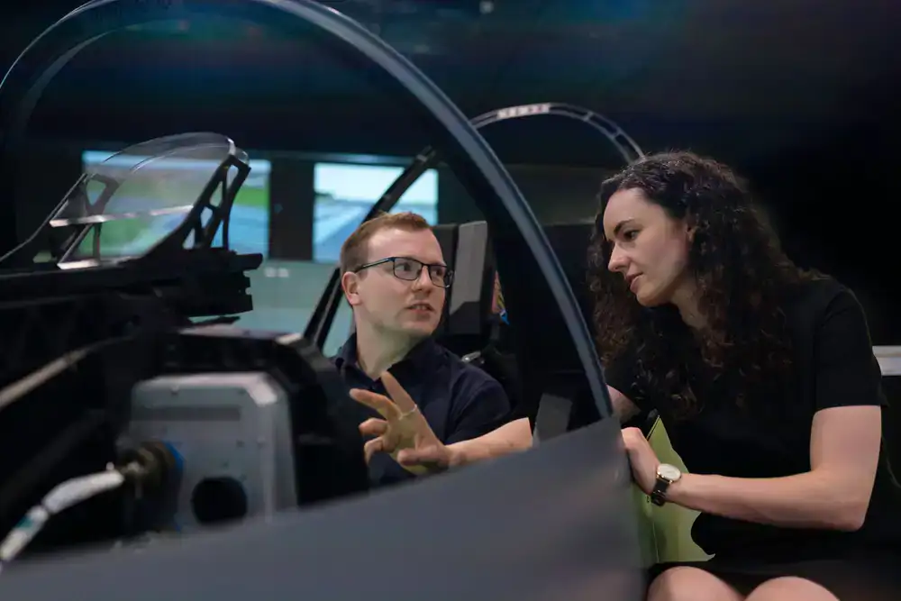 Colleagues collaborating inside a realistic flight simulator