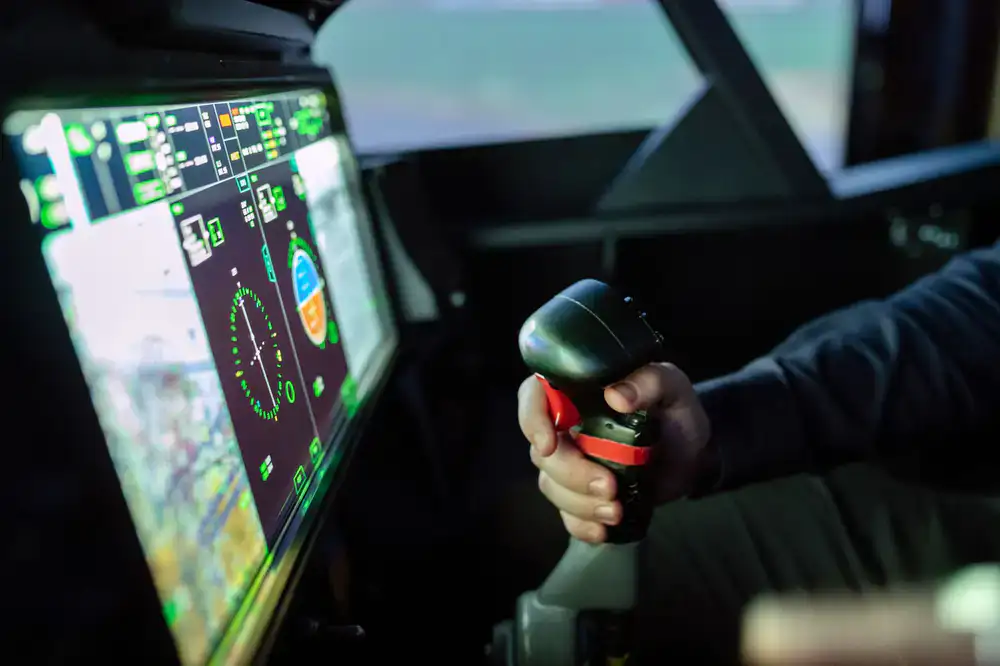 Detailed flight simulator cockpit at sunset