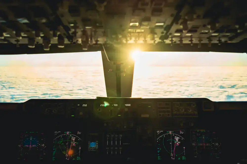 View out of a commercial aircraft cockpit during sunset